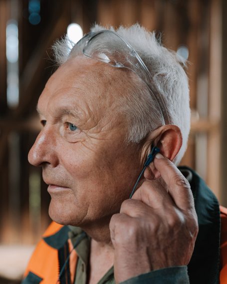 Anwendung des maßgefertigten Hörluchs Gehörschutzes in Industrieumgebung zur Prävention von lärmbedingten Hörschäden.